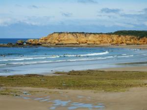 a group of people in the water at a beach at At the Gallery in Torquay