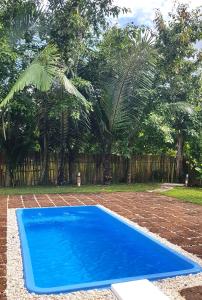 a blue rectangle trampoline in a yard with trees at Chiang Dao Reset in Chiang Dao