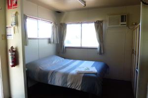 a bedroom with a bed and a window at Horsham Riverside Caravan Park in Horsham