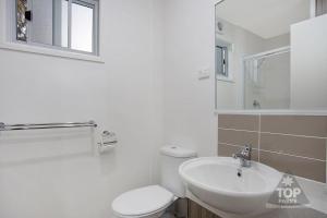 a bathroom with a sink, toilet and mirror at Horsham Riverside Caravan Park in Horsham