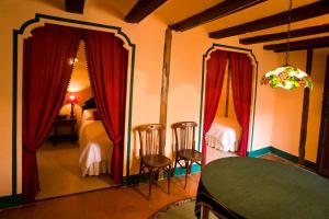 a room with a table and two chairs and a bedroom at Marques de Valdeolivo in Tronchón