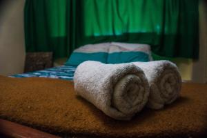 a pile of towels sitting on top of a bed at BiosWild in Cusco
