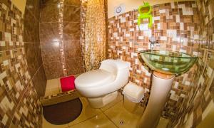 a bathroom with a toilet and a sink at BiosWild in Cusco