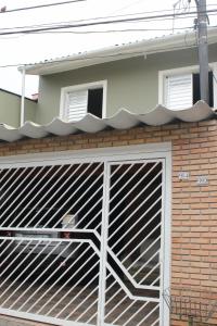 uma porta de garagem com um portão de metal num edifício em Casa mobiliada em São Paulo
