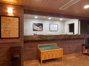 a waiting room with a brick wall and a counter at PACIFICO Hotel and Spa in Iwaki