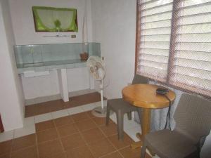 a small room with a table and a fan at Royal Cliff Resort in Siquijor