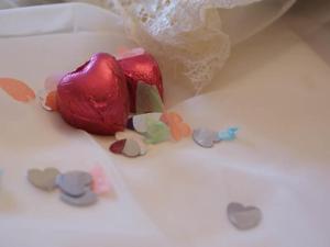 a red heart shaped candy on a white cake at The Ambassador Townhouse in Southport