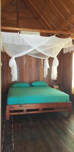 a bedroom with a bed with a canopy at Sunari Beach Resort 2 in Padang