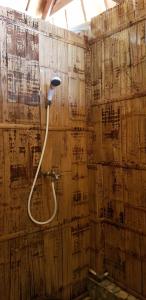 a bathroom with a hose attached to a wall at Sunari Beach Resort 2 in Selayar +146 photos