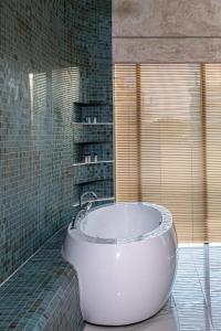 una vasca bianca in un bagno con finestra di Sunway Hotel a Kallithea