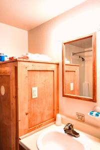 a bathroom with a sink and a mirror at Turning Leaf Townhome Suites in Spokane