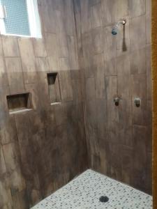 a bathroom with a shower with a glass door at Casa Hacienda San Gabriel in Cozumel