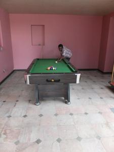 a young boy playing with a pool table at Earl's Red Passikudah in Pasikuda
