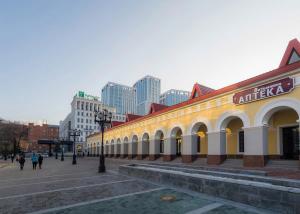 a building in a city with people walking on a street at Апартаменты Азбука на Верхнеторговой площади 4 in Ufa