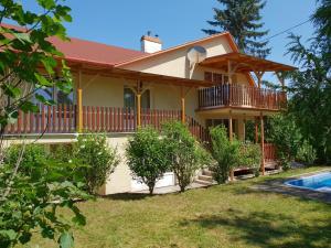 a house with a balcony and a swimming pool at Ferienhaus Alexandra in Balatonberény