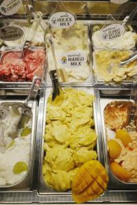 a buffet filled with different types of food in trays at GHEE GELATO HOUSE in Bangkok