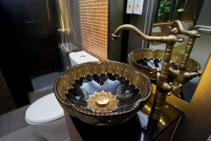 a bathroom with two sinks and a toilet at GHEE GELATO HOUSE in Bangkok +14 photos
