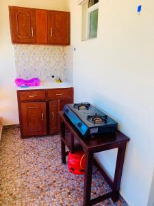 a kitchen with a table with a stove on it at Le Paradis Nyali in Mombasa