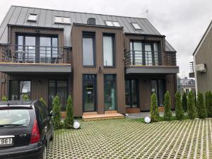 a house with a car parked in front of it at Rainbow Palanga in Palanga