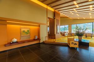 a lobby with a large room with a large window at Izu Mitohama Shotokan in Numazu