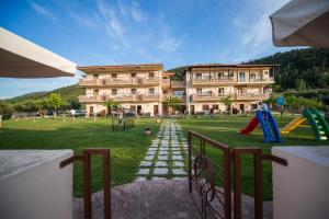 a large building with a playground in front of it at Aroma Studios and Apartments in Vourvourou
