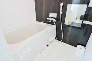 a bathroom with a white sink and a mirror at momo premium 401 in Sapporo