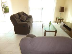 a living room with a couch and a coffee table at Villa Magnolia in Coral Bay