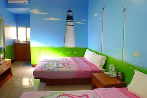 A bed or beds in a room at Hai Zhi Dao Min Su