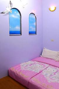 A bed or beds in a room at Hai Zhi Dao Min Su