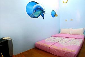 A bed or beds in a room at Hai Zhi Dao Min Su