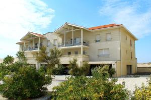 a large white building with trees in front of it at BiscaOcéan in Biscarrosse-Plage