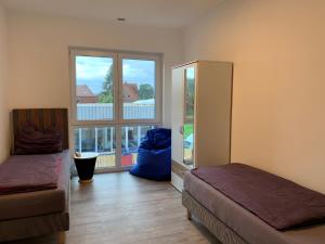 a room with two beds and a large window at Urban Apartement-Boardinghouse Wadersloh in Wadersloh
