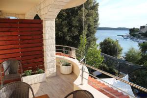 a balcony with chairs and a view of the water at Apartments Time Off in Zaboric