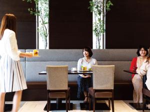 two women sitting at a table with plates of food at Hotel JAL City Haneda Tokyo in Tokyo