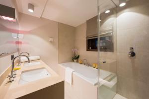 a bathroom with a sink and a shower at Nidus Luxury Apartments in Lech am Arlberg