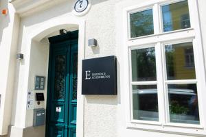 a building with a green door and a sign on it at EST Residence Schönbrunn - Apartments in Vienna