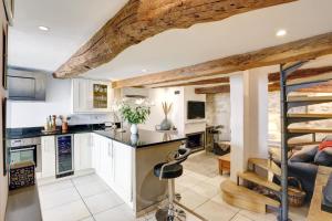 a kitchen with a staircase and a living room at Heart Of Valbonne in Valbonne