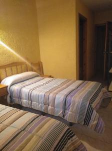 Postel nebo postele na pokoji v ubytování Pensión Rural Arroyo la Teja