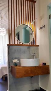 a bathroom with a sink and a mirror at Rotunda Suites in Kalamaki Chanion