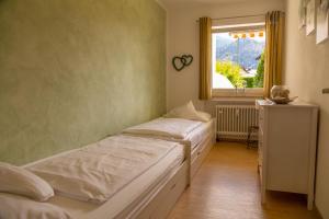 a bedroom with two beds and a window at Apartment Sophia in Garmisch-Partenkirchen