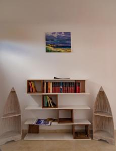 a living room with two bookshelves and a table at Casa Baran Vama Veche in Vama Veche