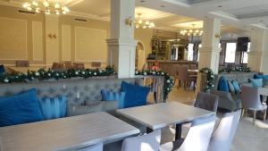 a restaurant with tables and chairs and christmas decorations at Family Hotel Residence in Dobrich