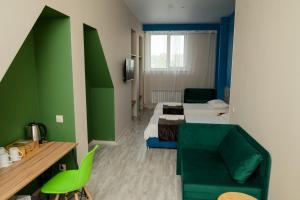 a hotel room with a bed and a couch at 7 rooms Hotel in Novokuznetsk