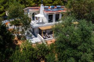an aerial view of a white house with trees at Ktima Fabiatos in Skala