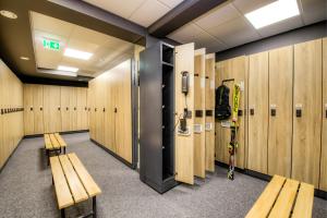 a room with benches and lockers in a gym at Hotel Rose in Mayrhofen