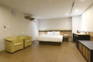 Voodi või voodid majutusasutuse 鼎立安商務旅館 Dinglian Hotel toas