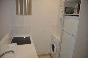 a small kitchen with a washing machine and a washer at APARTAMENTO ICEBERG TARIFA in Tarifa