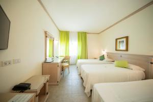 Postel nebo postele na pokoji v ubytování Mancini Park Hotel + 37 fotografií