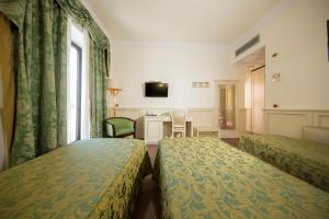Cama o camas de una habitación en Mancini Park Hotel