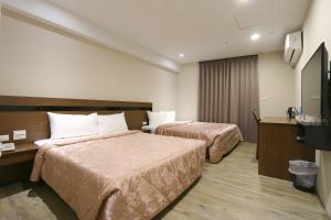 Giường trong phòng chung tại 鼎立安商務旅館 Dinglian Hotel
